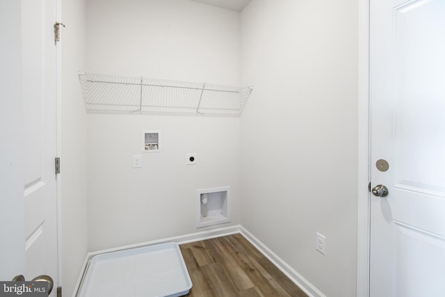 clothes washing area featuring baseboards, dark wood finished floors, laundry area, hookup for a washing machine, and electric dryer hookup