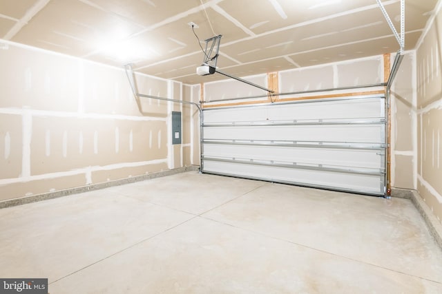 garage featuring electric panel and a garage door opener