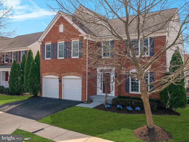 view of front facade featuring a front lawn, an attached garage, brick siding, and driveway