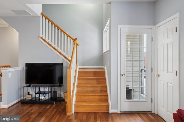 entrance foyer with stairs, baseboards, visible vents, and wood finished floors