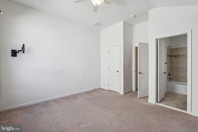 unfurnished bedroom featuring baseboards, carpet, and vaulted ceiling