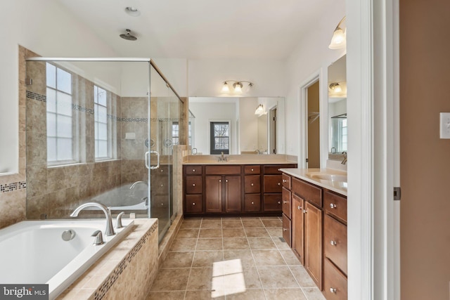 full bathroom with vanity, a shower stall, a bath, and tile patterned flooring