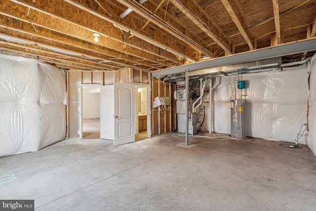 unfinished basement featuring heating unit and water heater