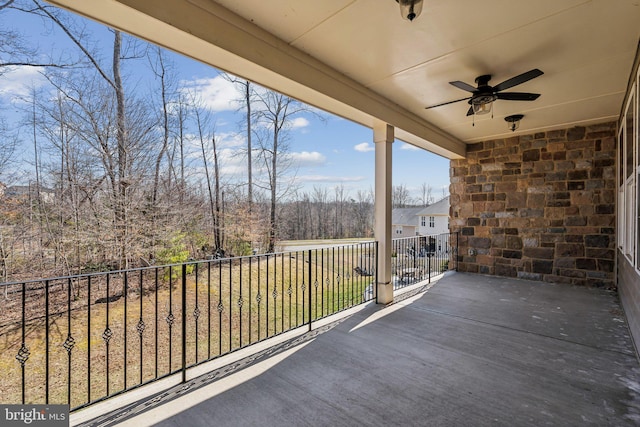 view of patio with a balcony and ceiling fan