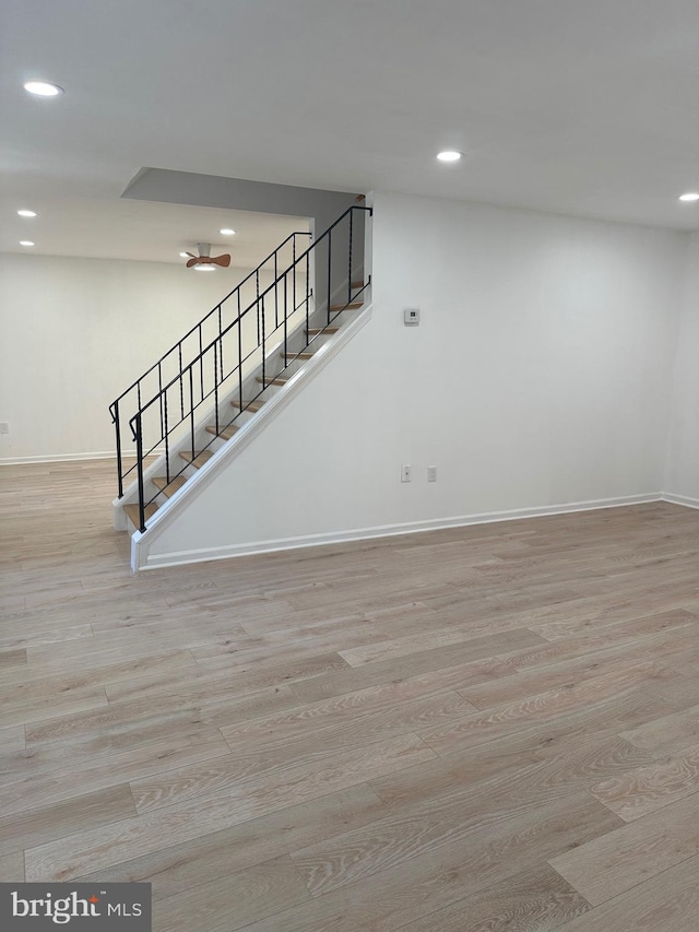 below grade area with stairway, recessed lighting, baseboards, and wood finished floors