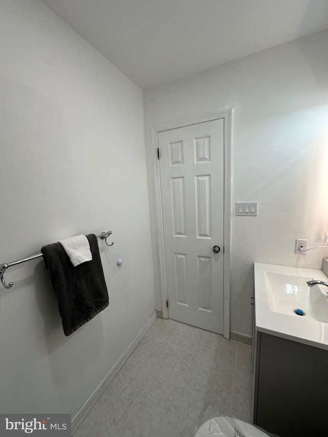 bathroom featuring baseboards and vanity