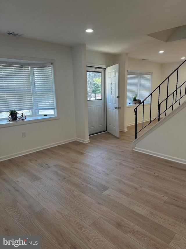 foyer entrance with stairs, recessed lighting, visible vents, and light wood finished floors