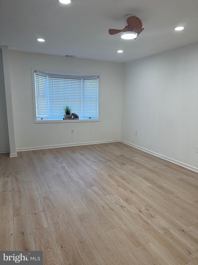 spare room with recessed lighting, wood finished floors, and baseboards