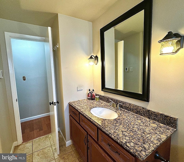 bathroom with vanity, tile patterned floors, and baseboards