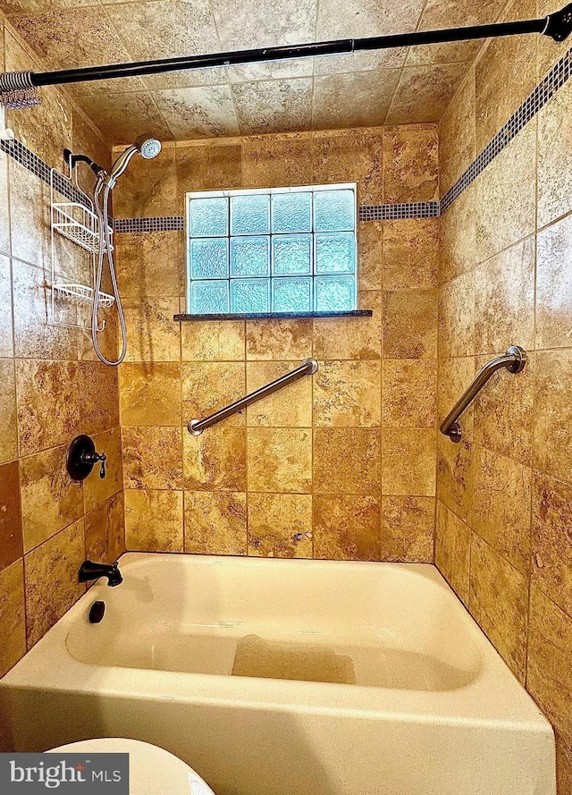 bathroom with toilet and shower / bath combination