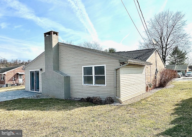 view of property exterior with a chimney and a yard