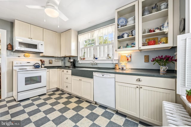 901 S Talbot, Saint Michaels, MD 21663 - kitchen featuring ceiling fan, white appliances, glass insert cabinets, light floors, and dark countertops