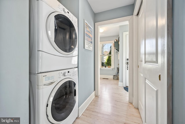 901 S Talbot, Saint Michaels, MD 21663 - laundry room with light wood finished floors, stacked washer / dryer, baseboards, and laundry area
