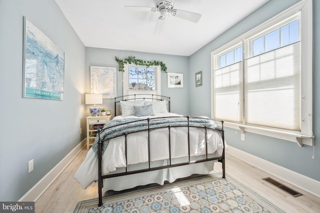 901 S Talbot, Saint Michaels, MD 21663 - bedroom with wood finished floors, baseboards, multiple windows, and visible vents
