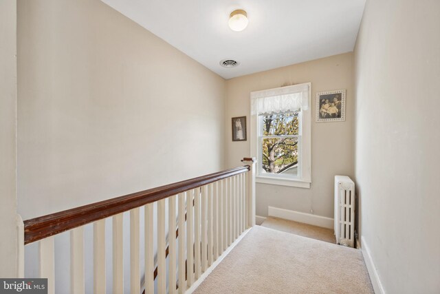 901 S Talbot, Saint Michaels, MD 21663 - hallway featuring baseboards, an upstairs landing, carpet floors, visible vents, and radiator