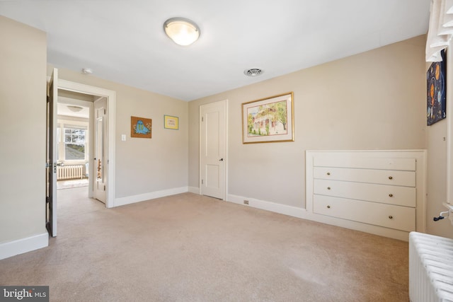 901 S Talbot, Saint Michaels, MD 21663 - unfurnished bedroom with visible vents, baseboards, radiator heating unit, and light colored carpet