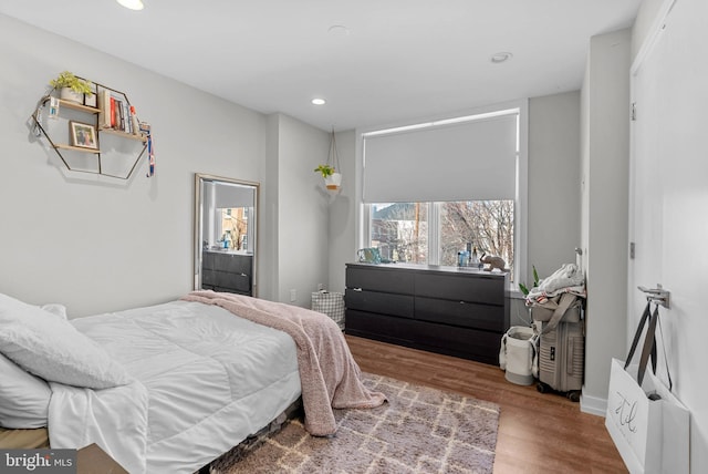 bedroom with recessed lighting and wood finished floors