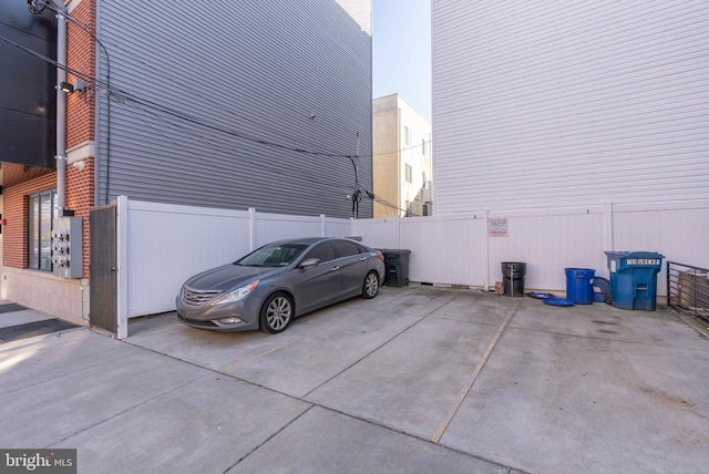 view of parking featuring fence