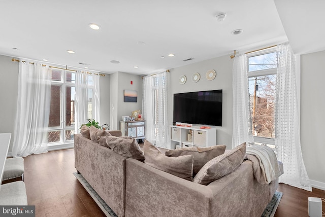 living room with recessed lighting, baseboards, and hardwood / wood-style flooring