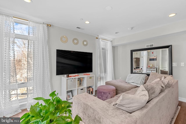 living area featuring visible vents, recessed lighting, and wood finished floors