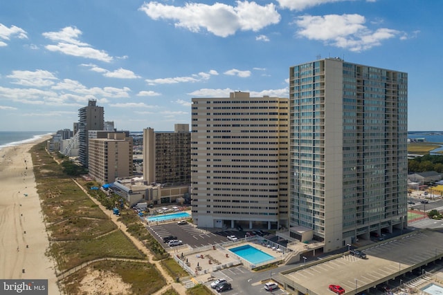 aerial view featuring a view of city, a beach view, and a water view