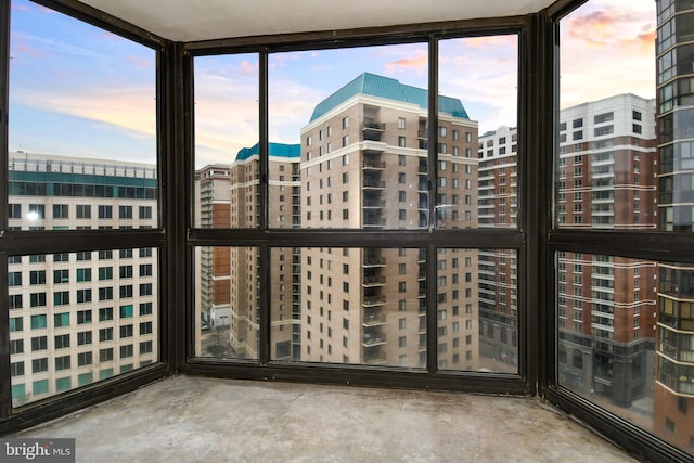 unfurnished sunroom with a city view