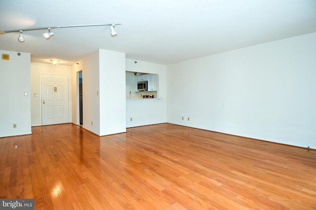 unfurnished living room featuring light wood-type flooring