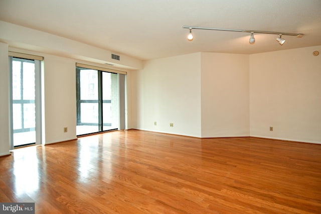 unfurnished room with visible vents, baseboards, and light wood-style floors