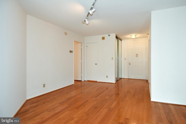 unfurnished room featuring light wood-style floors and baseboards