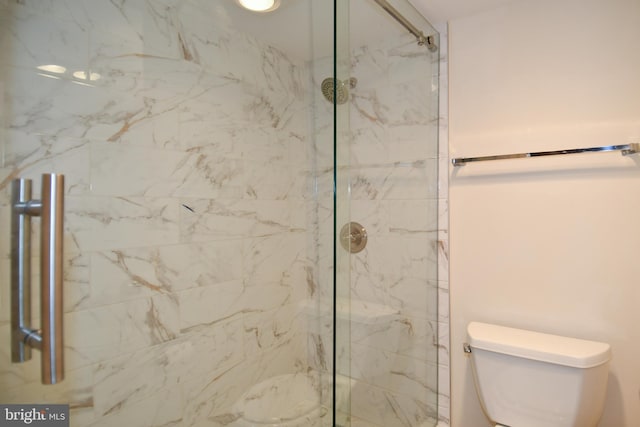 full bathroom featuring a marble finish shower and toilet