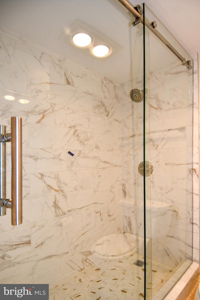 bathroom with a marble finish shower