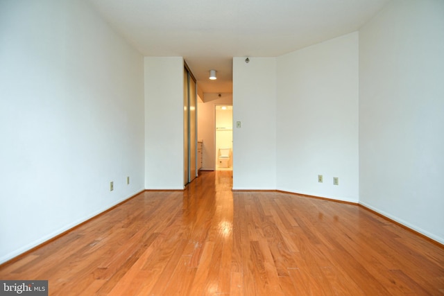 unfurnished room featuring light wood-type flooring and baseboards