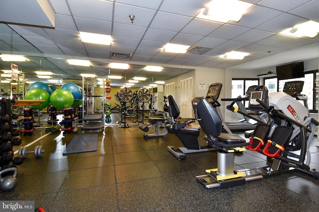 workout area with visible vents and a paneled ceiling