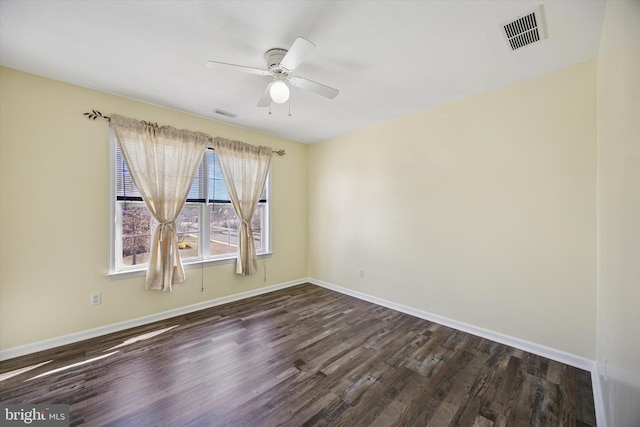 unfurnished room featuring ceiling fan, visible vents, baseboards, and dark wood-style floors