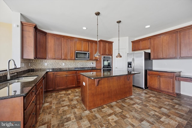 kitchen with dark stone countertops, tasteful backsplash, appliances with stainless steel finishes, and a sink