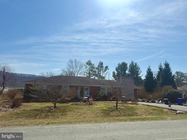 ranch-style home with a front lawn