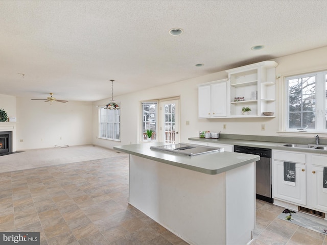 kitchen featuring stainless steel dishwasher, plenty of natural light, stovetop with downdraft, and a kitchen island