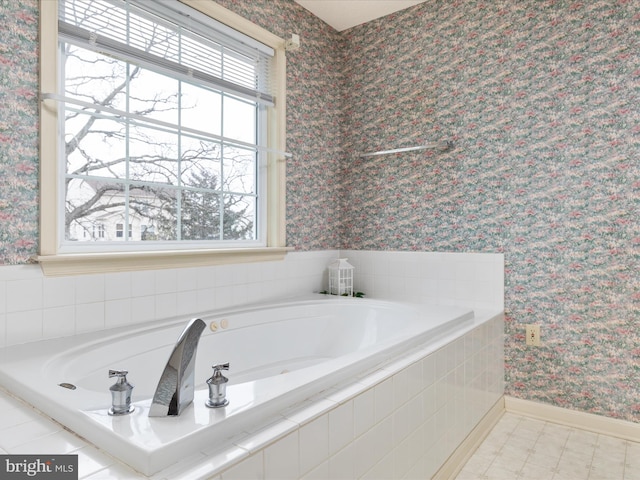 full bath featuring a garden tub, wallpapered walls, and baseboards