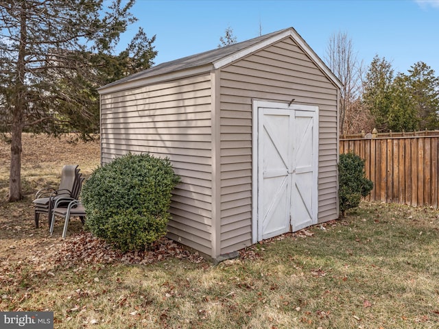 view of shed featuring fence