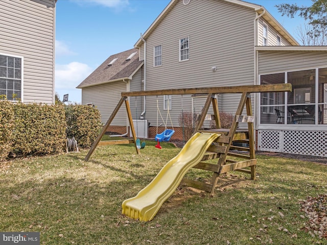 view of play area with a yard and a sunroom