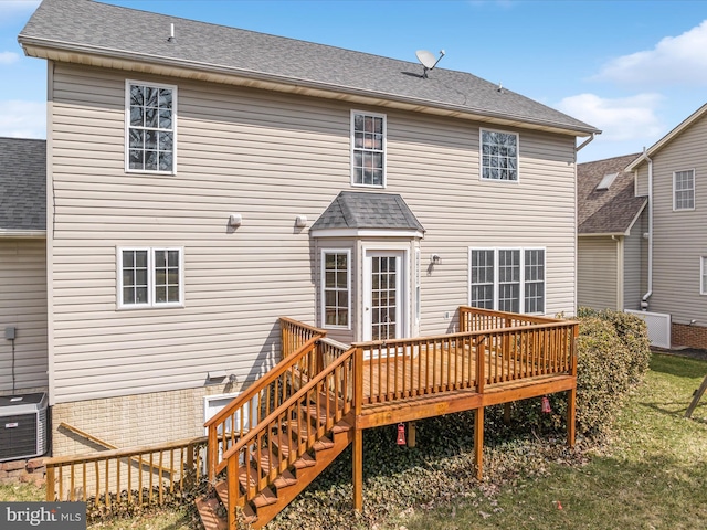 back of house with central AC, a deck, and a shingled roof