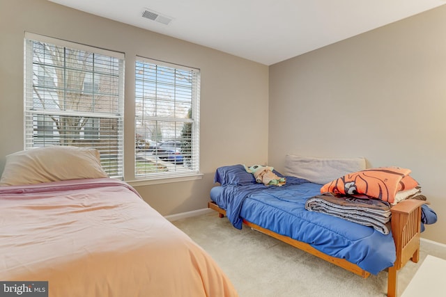 carpeted bedroom with baseboards and visible vents