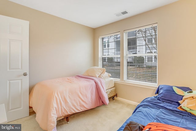 carpeted bedroom with baseboards and visible vents