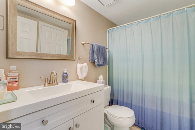 full bathroom with toilet and vanity