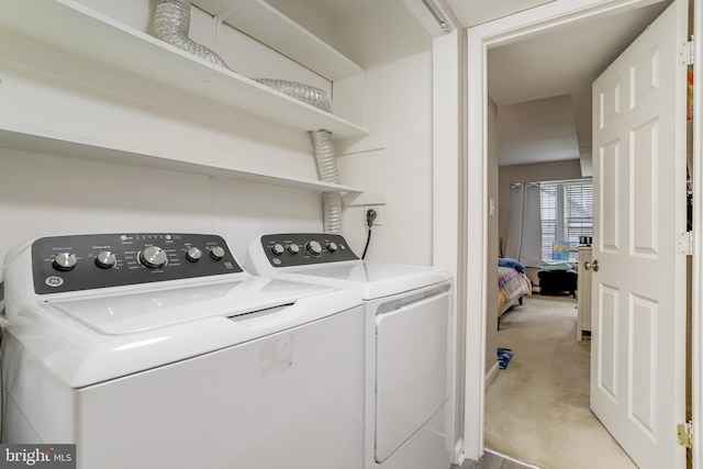 laundry area with light colored carpet, independent washer and dryer, and laundry area