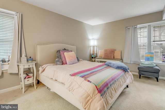 carpeted bedroom featuring baseboards