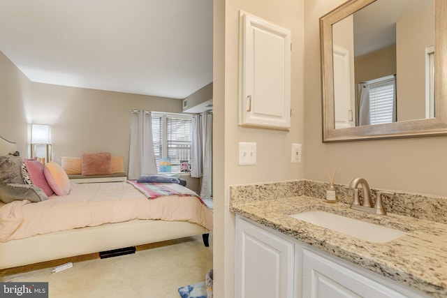 bedroom featuring carpet floors and a sink