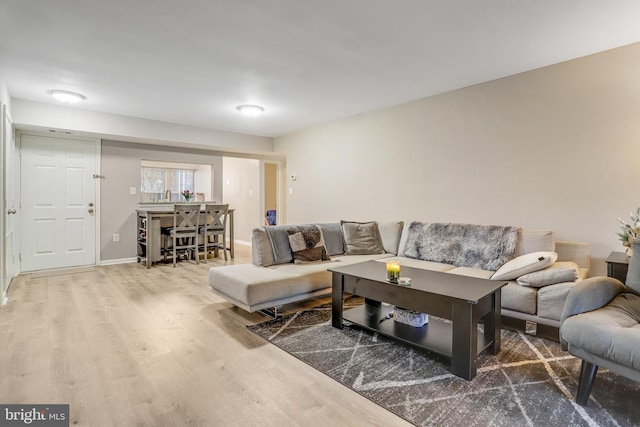 living room with baseboards and wood finished floors