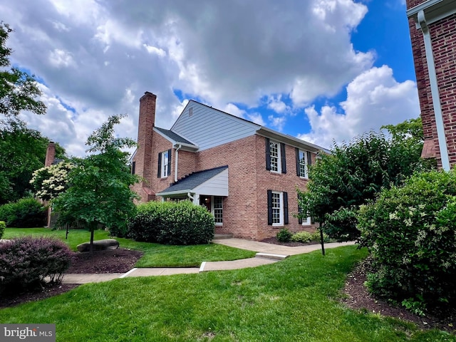 2512 S Arlington Mill Dr Unit 6, Arlington, VA 22206 - view of home's exterior featuring brick siding, a yard, and a chimney