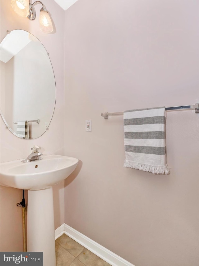 bathroom with tile patterned floors and baseboards